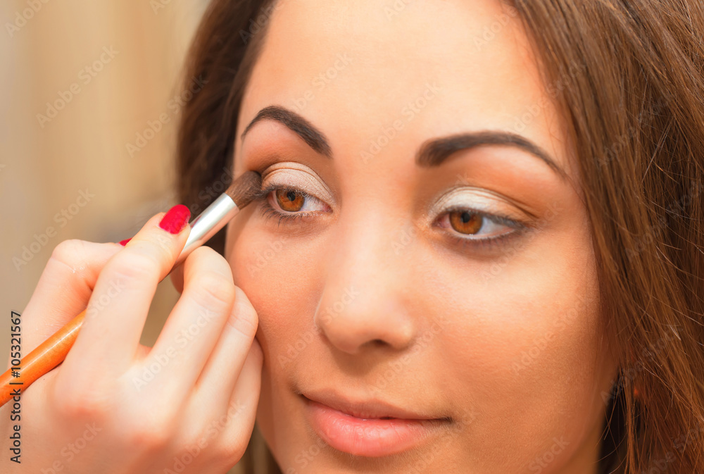 Applying eyeshadow on eyelid. Applying eyeshadow on eyelid.