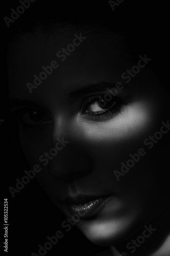 Artistic beauty portrait of young woman with creative lighting