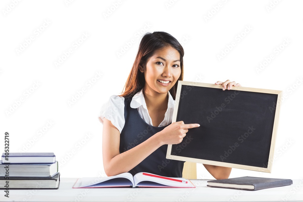 Smiling businesswoman pointing a blackboard Smiling businesswoman pointing a blackboard