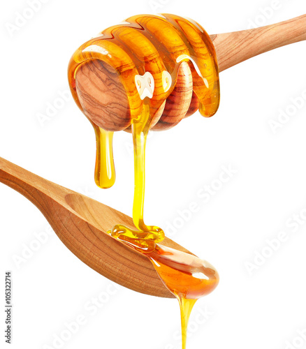 honey dripping on wooden spoon isolated on a white background