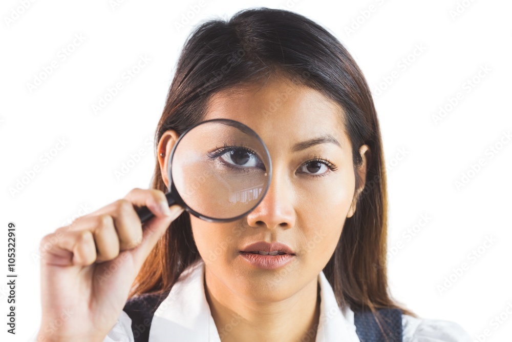 Businesswoman looking through magnifying glass Businesswoman looking through magnifying glass
