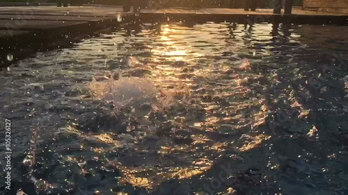 Wallpaper Mural slow motion water drop on a pool, silhouette in the evening Torontodigital.ca