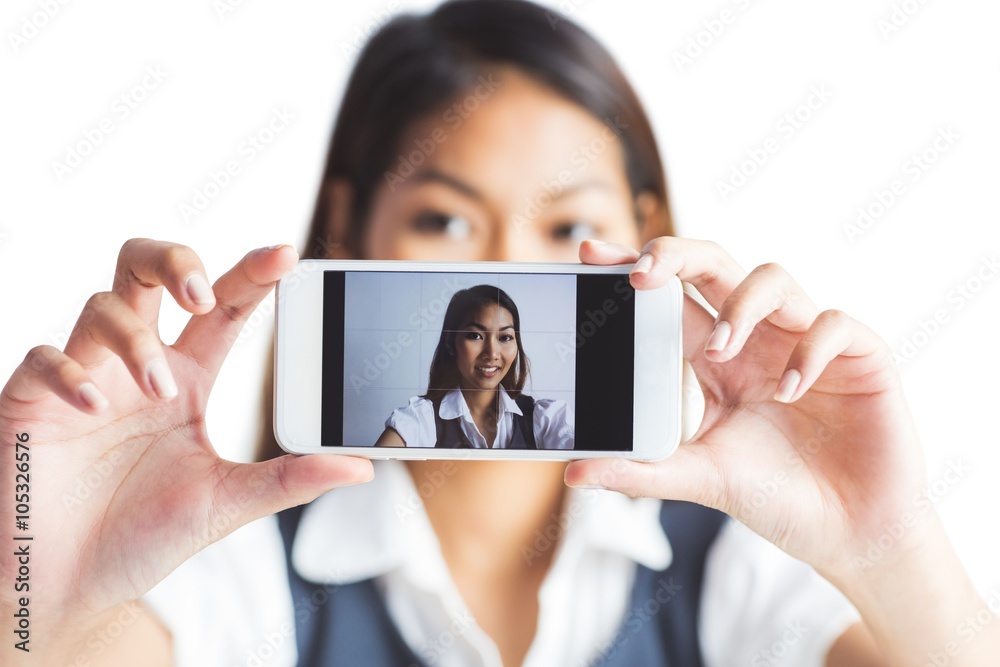 Businesswoman taking a selfie with a smartphone