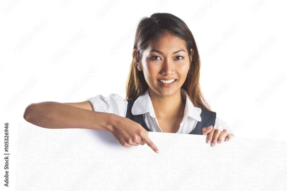Smiling businesswoman pointing a white poster Smiling businesswoman pointing a white poster