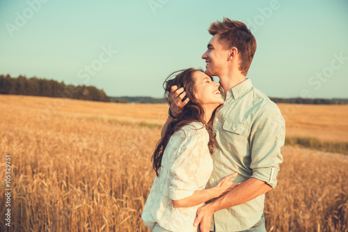 Young couple in love outdoor.Stunning sensual outdoor portrait of young stylish fashion couple posing in summer in field  © Elena Kratovich