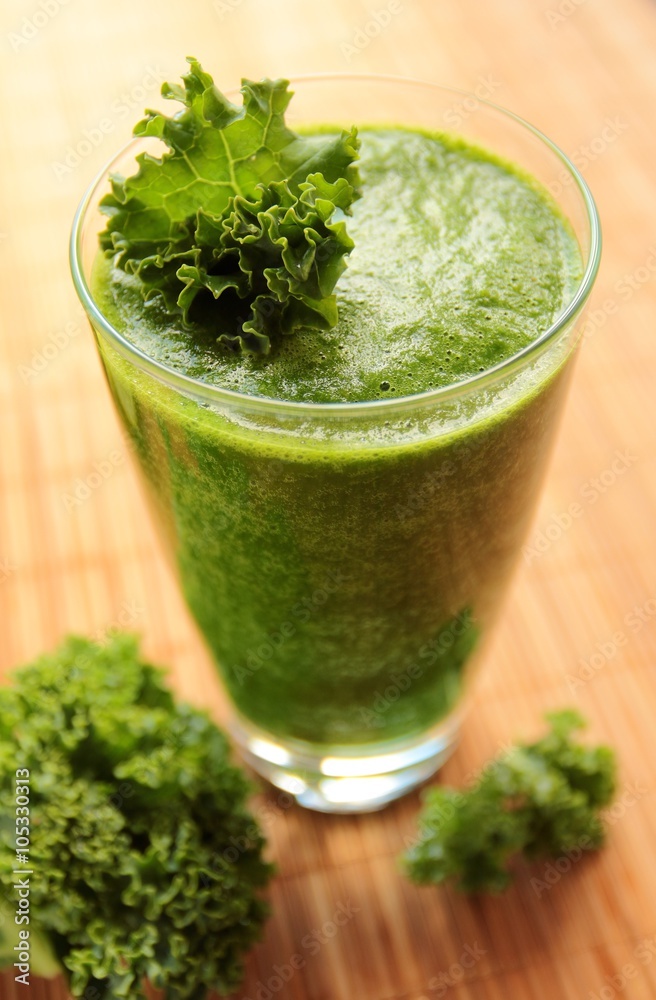 Healthy green smoothie with kale leafs in a glass Healthy green smoothie with kale leafs in a glass