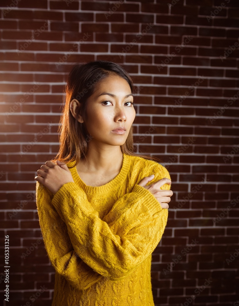 Serious asian woman with hands on shoulders Serious asian woman with hands on shoulders