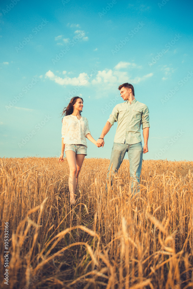 Young couple in love outdoor.Stunning sensual outdoor portrait of young stylish fashion couple posing in summer in field Young couple in love outdoor.Stunning sensual outdoor portrait of young stylish fashion couple posing in summer in field