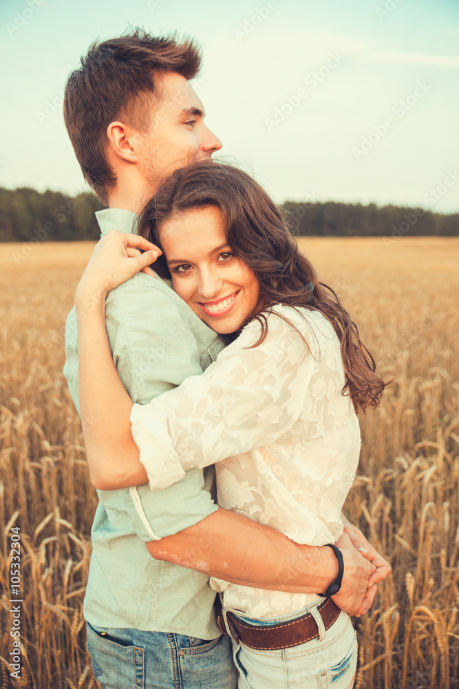 Young couple in love outdoor.Stunning sensual outdoor portrait of young stylish fashion couple posing in summer in field Young couple in love outdoor.Stunning sensual outdoor portrait of young stylish fashion couple posing in summer in field