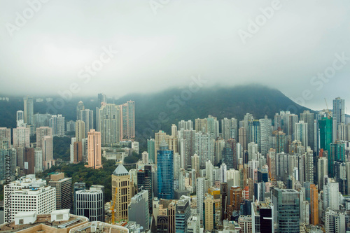 Skyscrapers on green hills before rain in Hong Kong