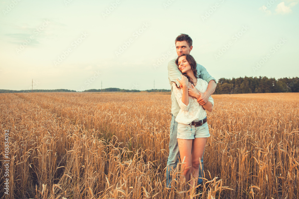 Young couple in love outdoor.Stunning sensual outdoor portrait of young stylish fashion couple posing in summer in field