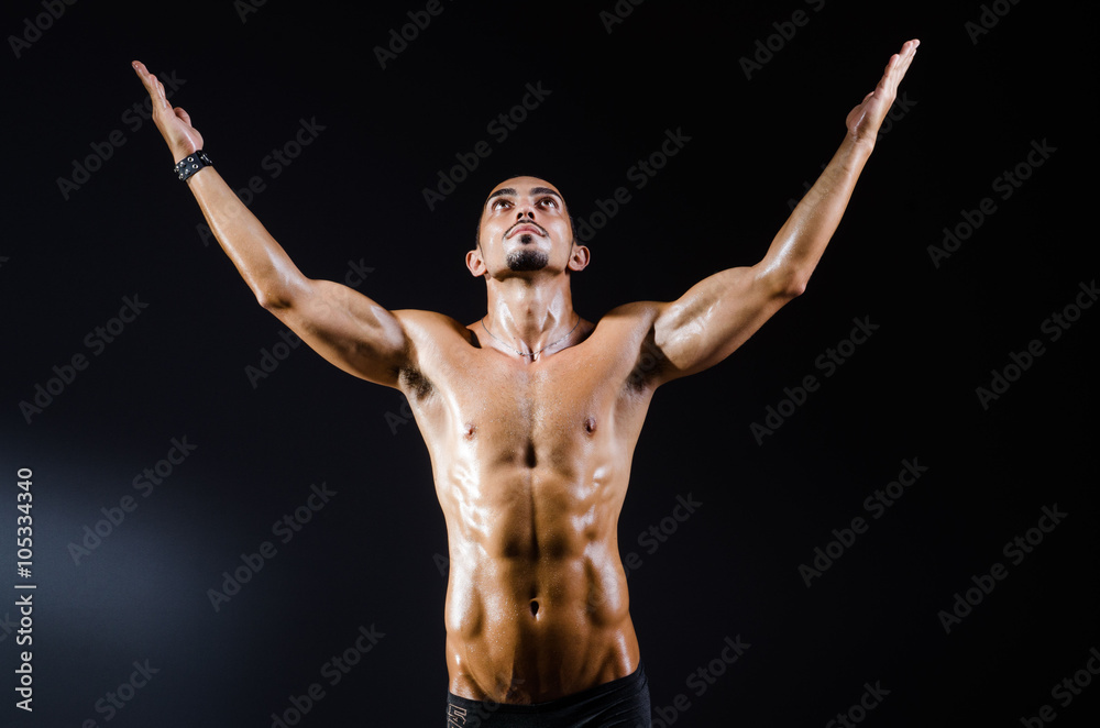 Ripped muscular man in sports concept