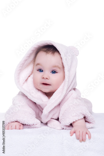 cute baby child in pink bathrobe lying down on blanket