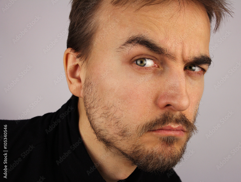Fototapeta premium portrait of a man, suspicious look, closeup