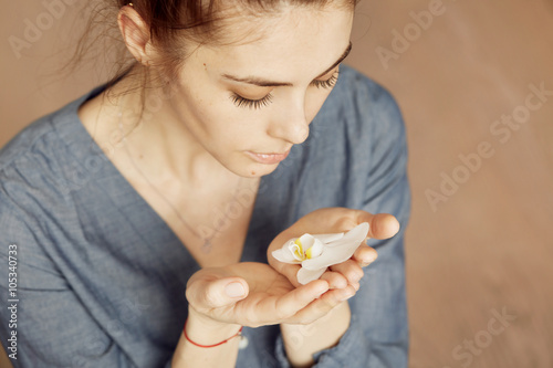 Woman hands holding a flower  with focus on a flower