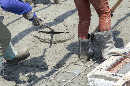 Shoes labor working on concrete at construction site