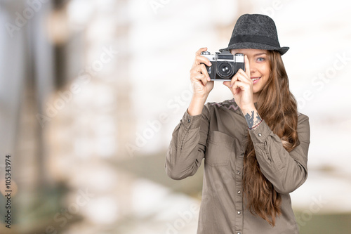 Young woman holding an old vintage camera © fotofabrika