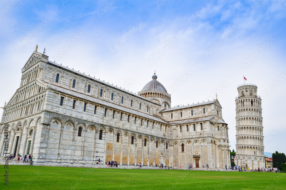 Wide view of the historic religious cathedral of Pisa and the famous leaning tower in Italy