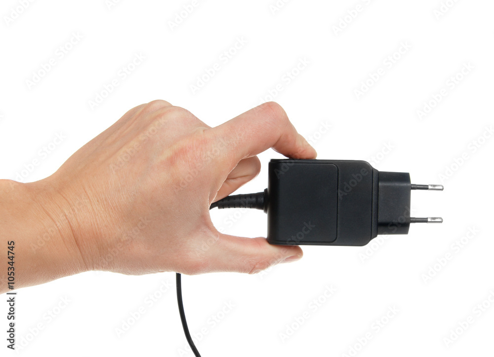 The electric adapter in a hand, isolated on the white The electric adapter in a hand, isolated on the white