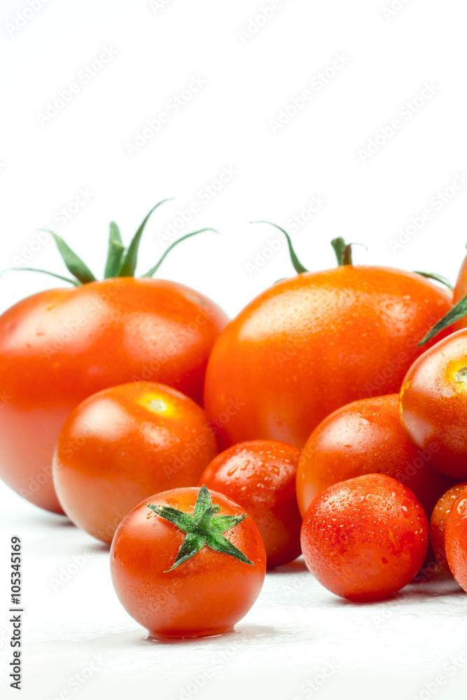 Tomatoes. Whole and a half isolated on white