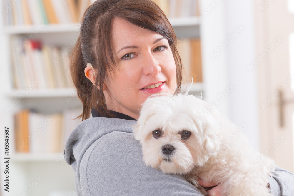 Woman wearing deaf aid with her dog Woman wearing deaf aid with her dog