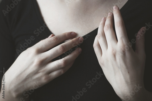 Close-up of woman's hands in front of her chest photo