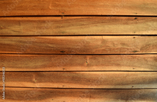 old wooden wall with nails hammered is orange tone