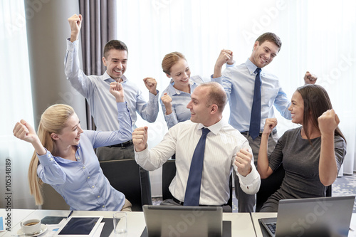business people celebrating victory in office