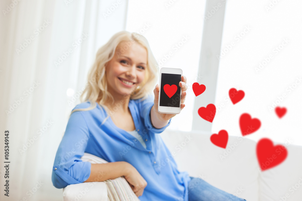 smiling woman with smartphone at home smiling woman with smartphone at home