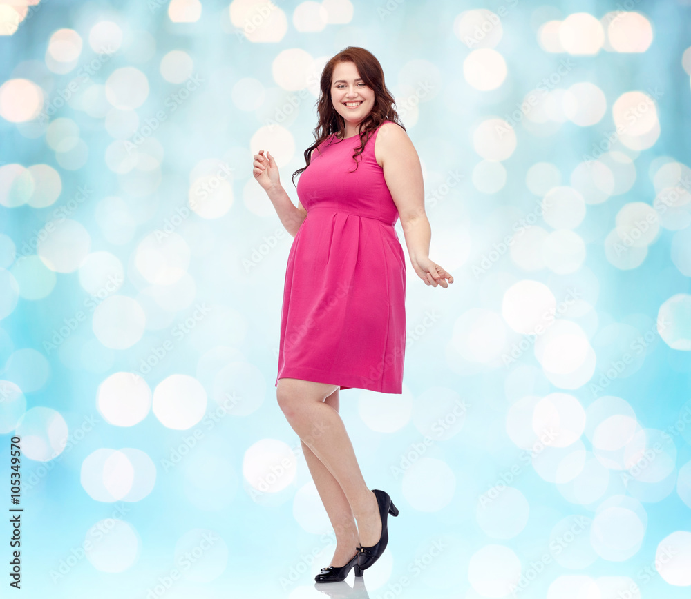 happy young plus size woman dancing in pink dress happy young plus size woman dancing in pink dress