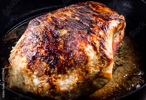 Roasted pork ham in dark ambient 