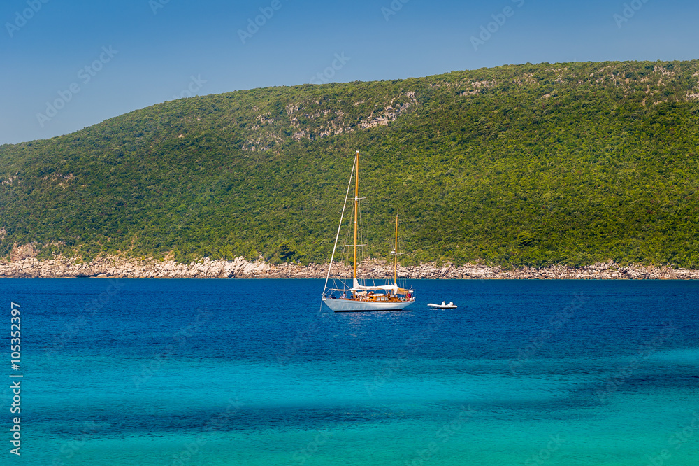 Sailing yacht at anchor in the beautiful Adriatic sea bay Sailing yacht at anchor in the beautiful Adriatic sea bay