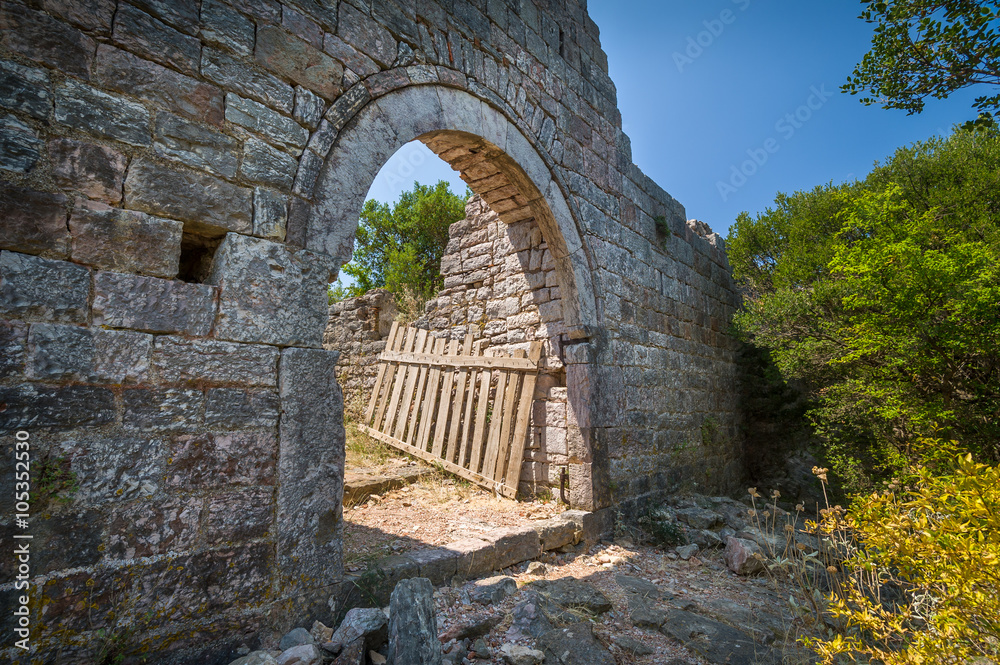Old gate in a stone fortress wall