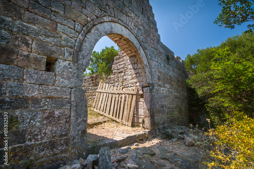 Old gate in a stone fortress wall