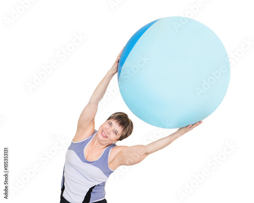 Portrait of pretty senior woman exercising with gymnastic ball on a white background 
