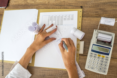 Female accountant or tax adviser working with receipts and stati photo