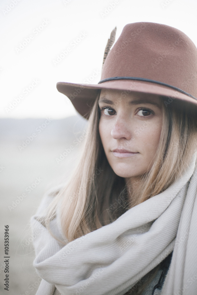 A woman in a wide brimmed hat with a scarf around her neck, A woman in a wide brimmed hat with a scarf around her neck,