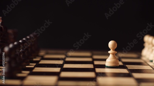 man playing wooden chess pieces