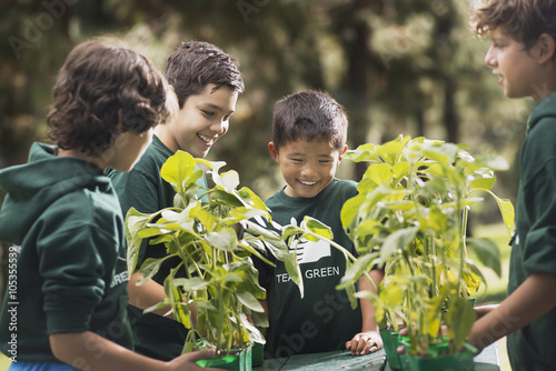 Children in a group learning about plants and flowers, in an afterschool club or summer camp, 