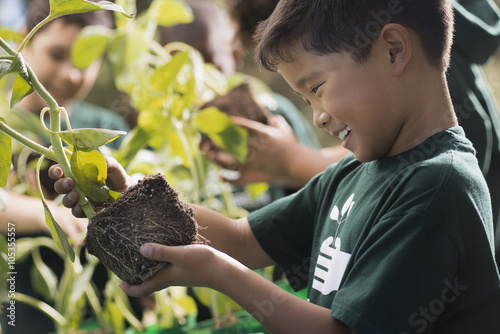 Children in a group learning about plants and flowers, in an afterschool club or summer camp, 