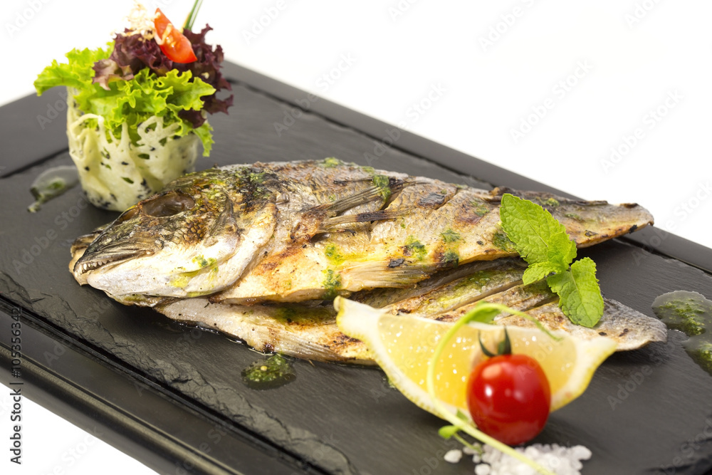 Fried fish dorado with vegetables and lemon Fried fish dorado with vegetables and lemon