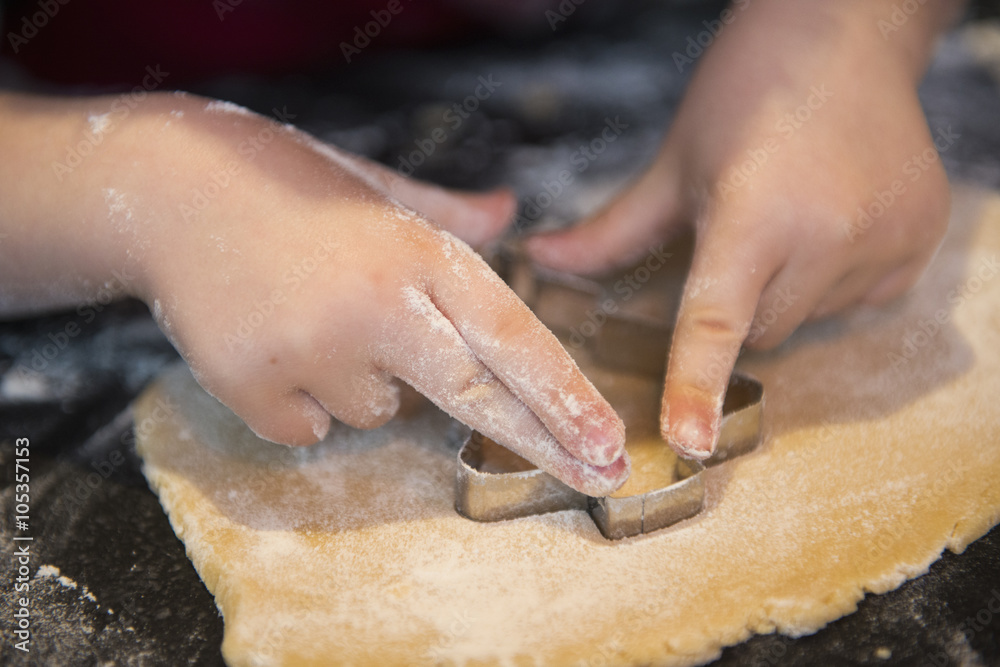 A child using a cookie cutter, making Christmas biscuits, A child using a cookie cutter, making Christmas biscuits,