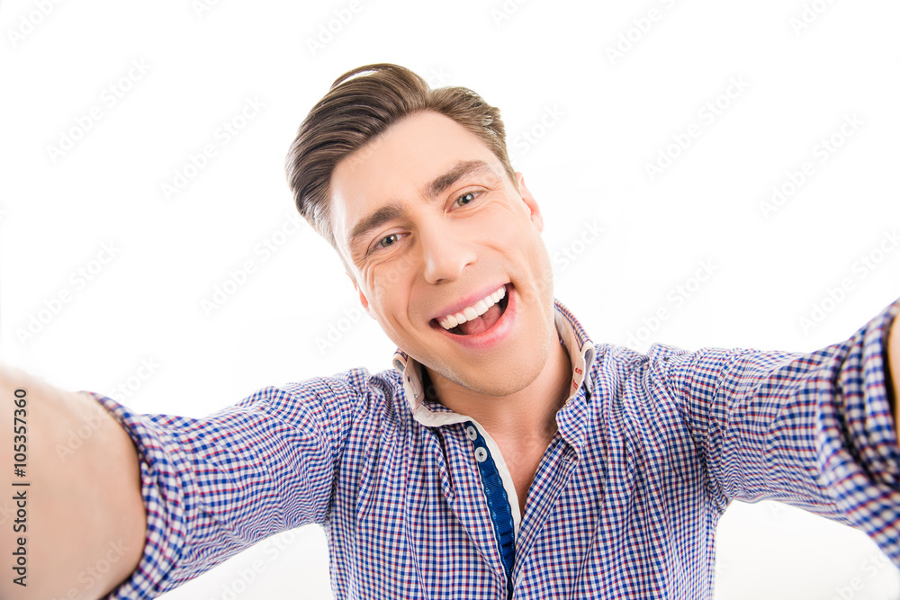 Attractive cheerful happy young man making selfie Attractive cheerful happy young man making selfie