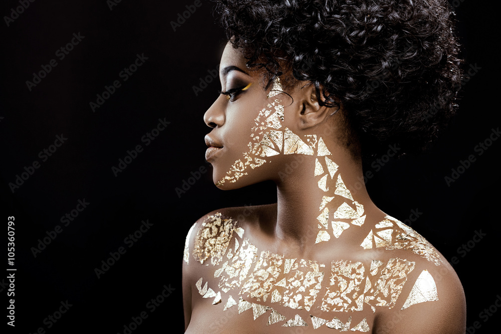 Side view of african girl posing on the black background