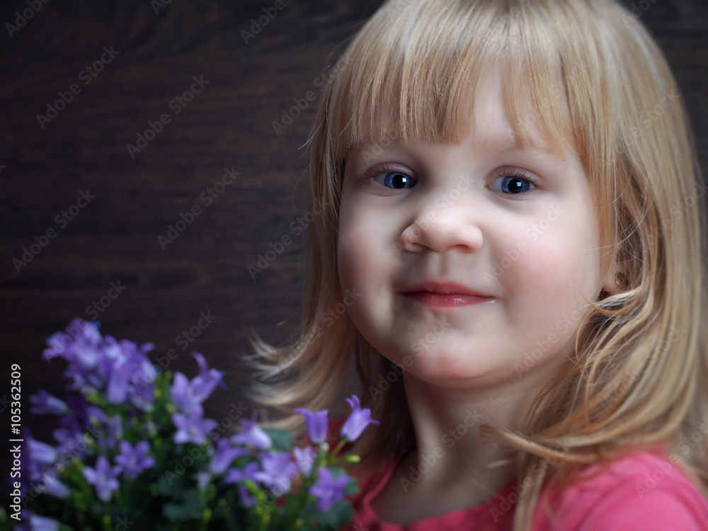 Little girl with a bouquet of wild flowers - wild bells Little girl with a bouquet of wild flowers - wild bells