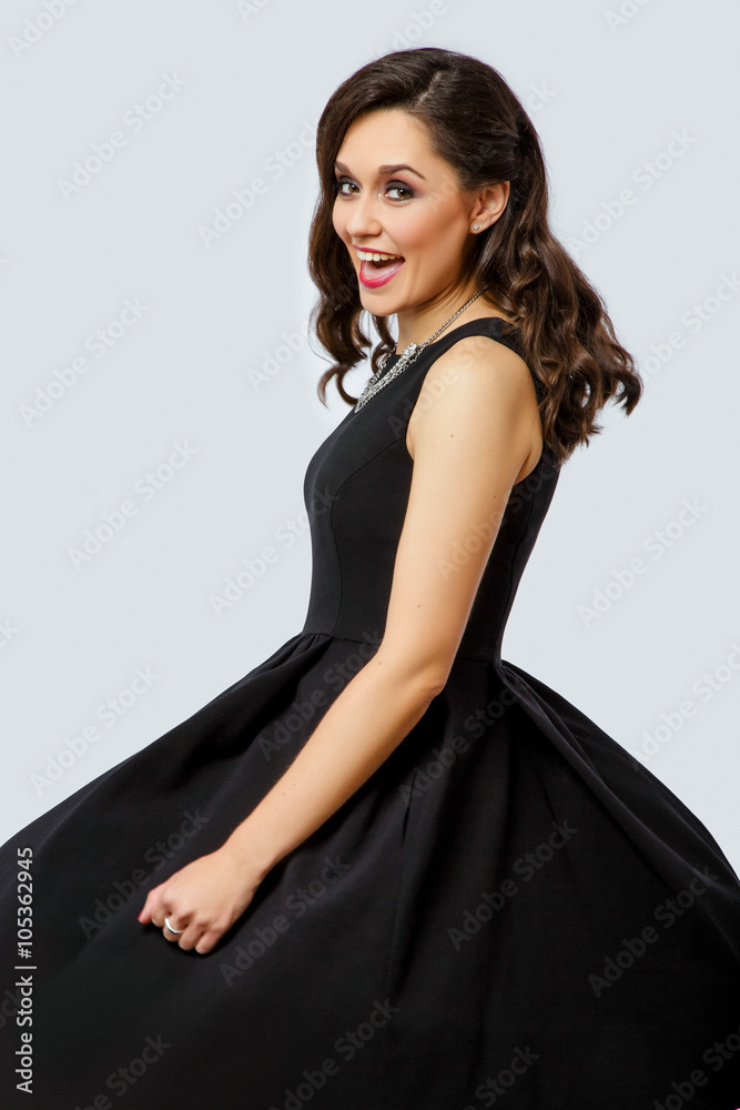 Charming young woman spinning on white background