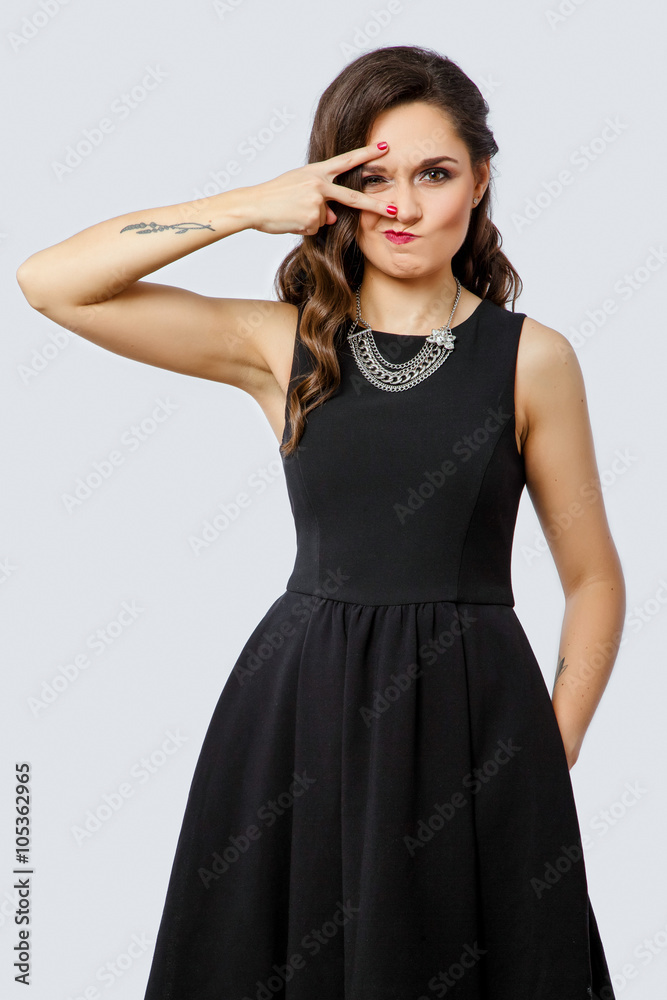 Positive brunette woman posing with hand near her face Positive brunette woman posing with hand near her face