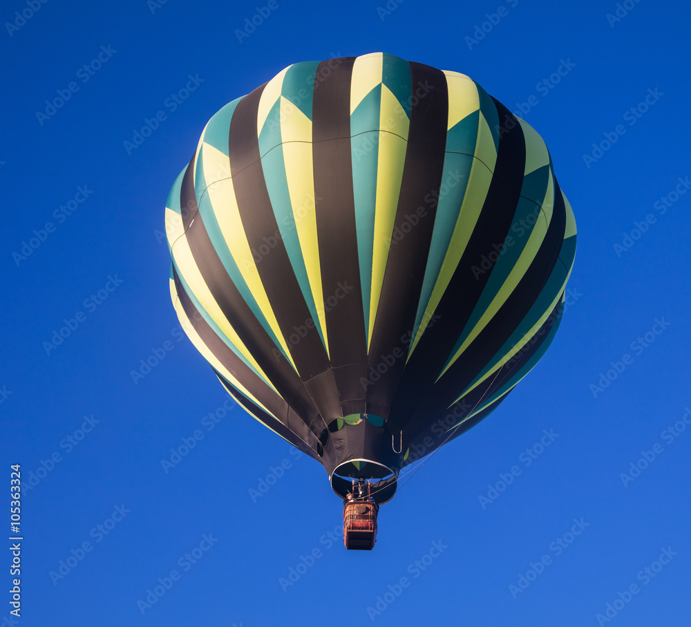 Fototapeta premium Hot air balloon against a deep blue sky just after launch