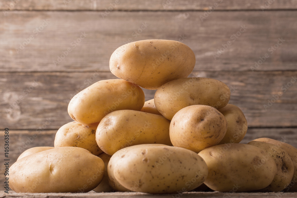 organic potatoes on wooden background organic potatoes on wooden background