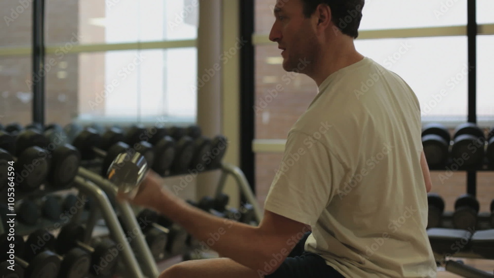 A man is weightlifting in the gym A man is weightlifting in the gym